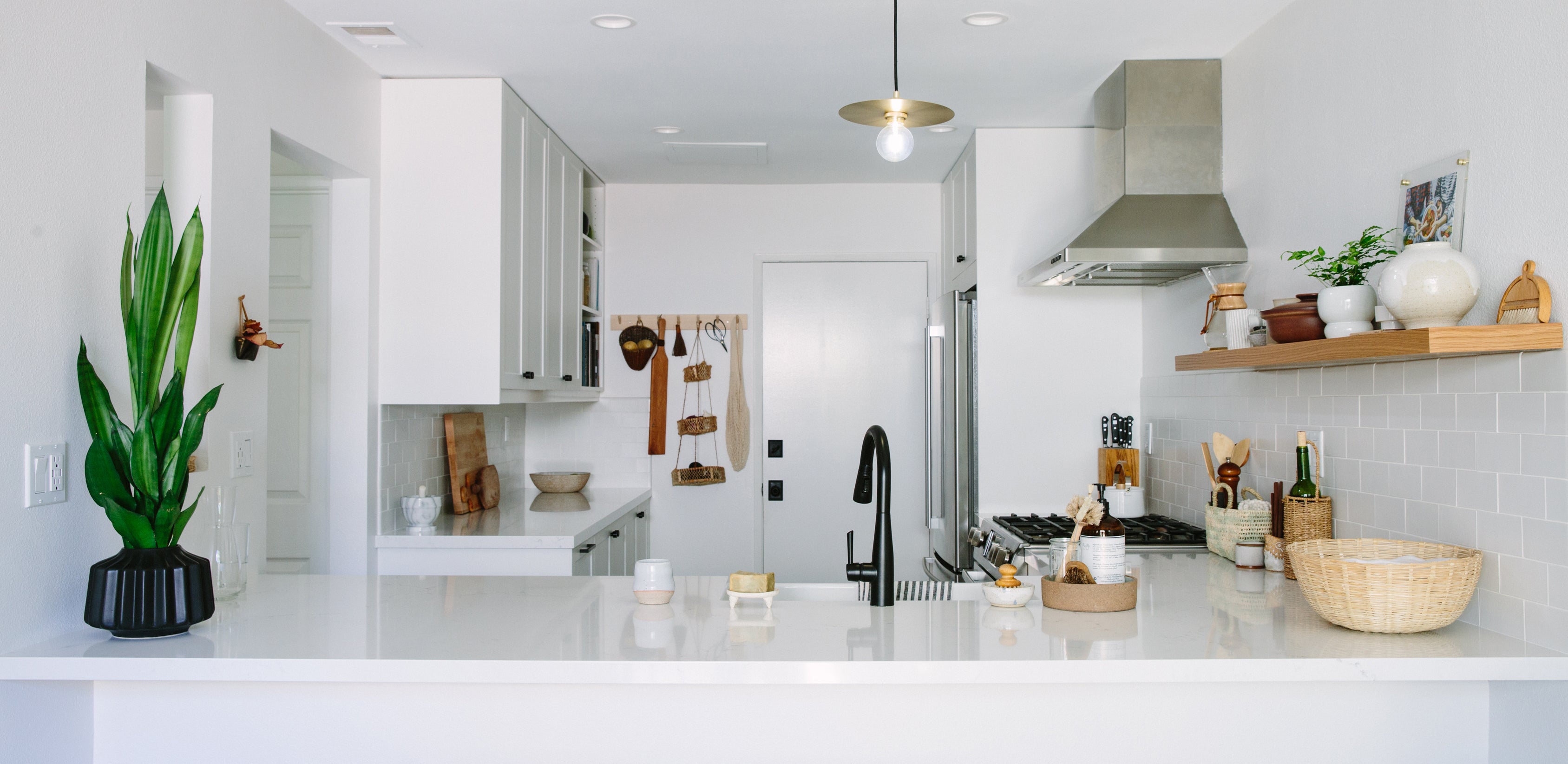 Bright White Cabinets and Floating Shelves Keep this Space Feeling Airy
