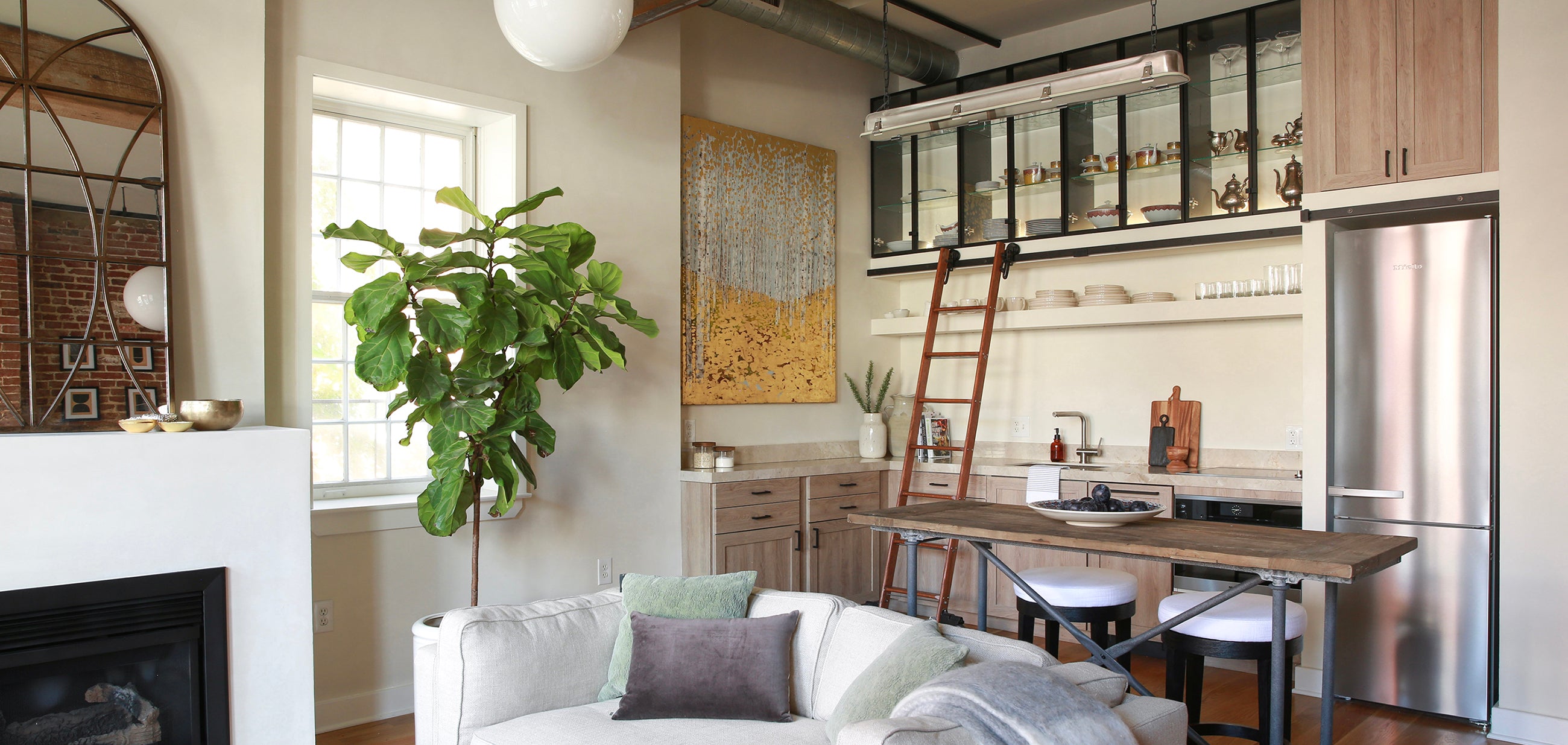 Rolling Library Ladder Opens Up this Small Euro Style Kitchen